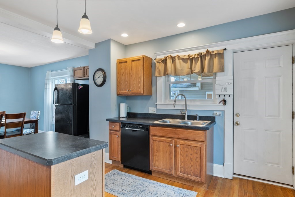 128 Shawmut Street Springfield, MA 01108 - Photo 18 of 39 a kitchen with stainless steel appliances granite countertop a refrigerator a sink a stove and island