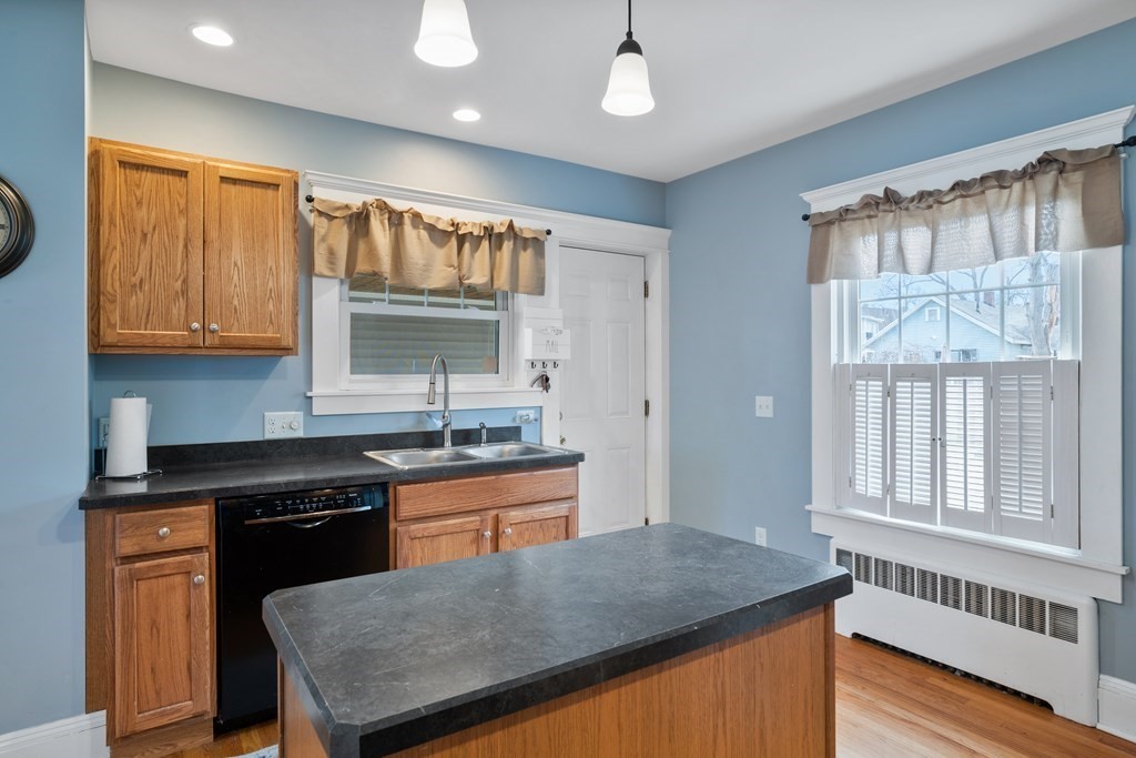 128 Shawmut Street Springfield, MA 01108 - Photo 19 of 39 a kitchen with granite countertop a stove a sink and a refrigerator
