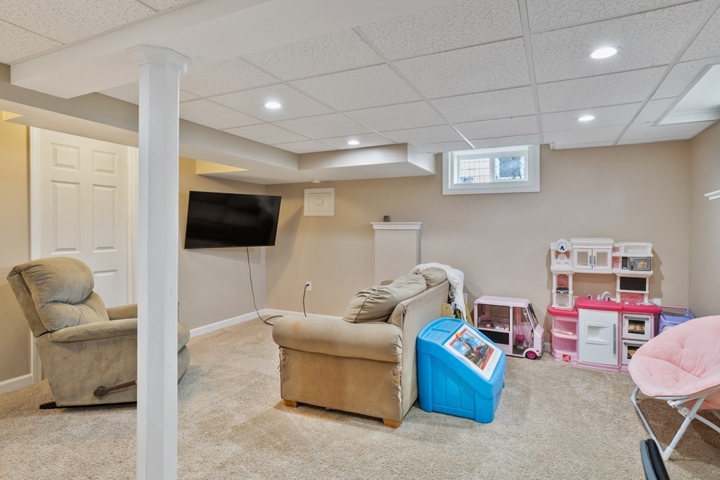 128 Shawmut Street Springfield, MA 01108 - Photo 21 of 39 a living room with furniture and a flat screen tv