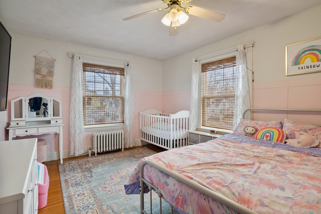 128 Shawmut Street Springfield, MA 01108 - Photo 24 of 39 a bedroom with a bed a dresser and a large window