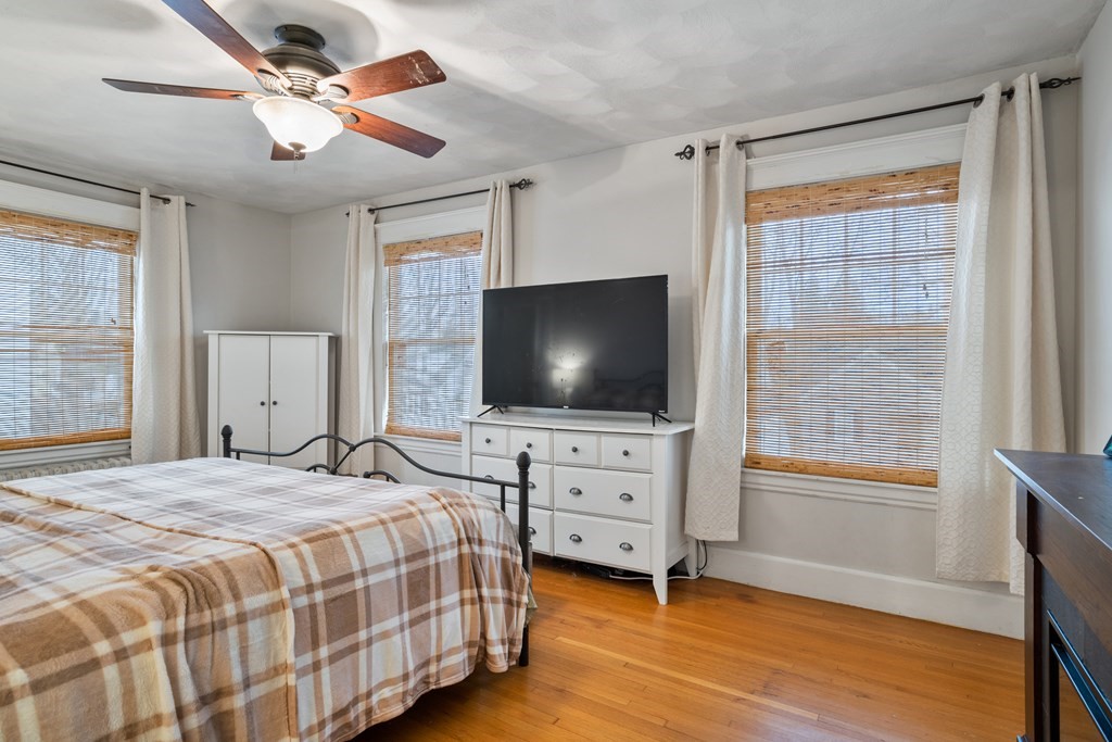 128 Shawmut Street Springfield, MA 01108 - Photo 28 of 39 a bedroom with a bed and a flat screen tv on dresser