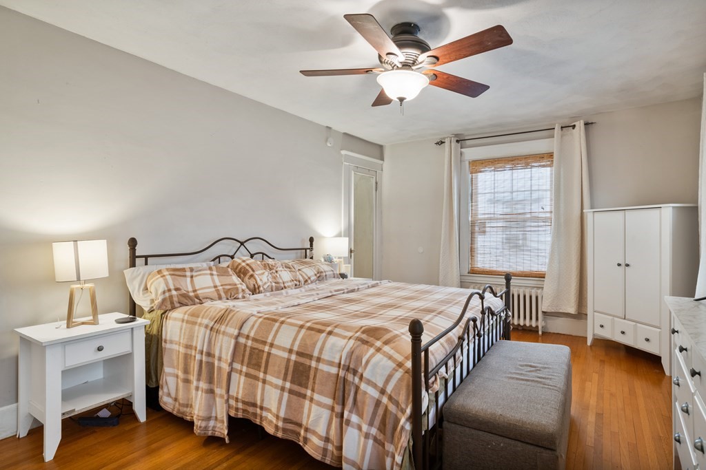 128 Shawmut Street Springfield, MA 01108 - Photo 29 of 39 a bedroom with a bed a window and a chandelier