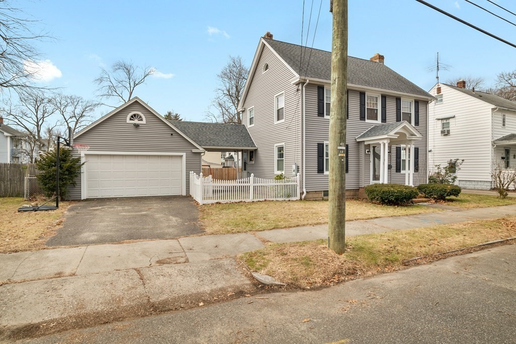 128 Shawmut Street Springfield, MA 01108 - Photo 3 of 39 a front view of a house with a yard and garage