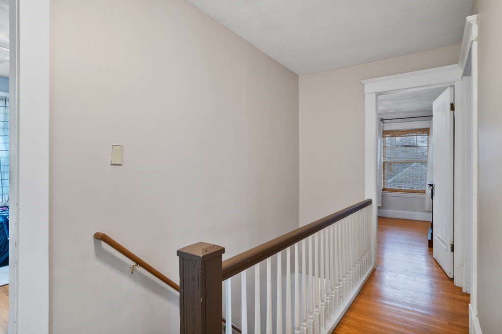 128 Shawmut Street Springfield, MA 01108 - Photo 34 of 39 a view of a hallway with wooden floor