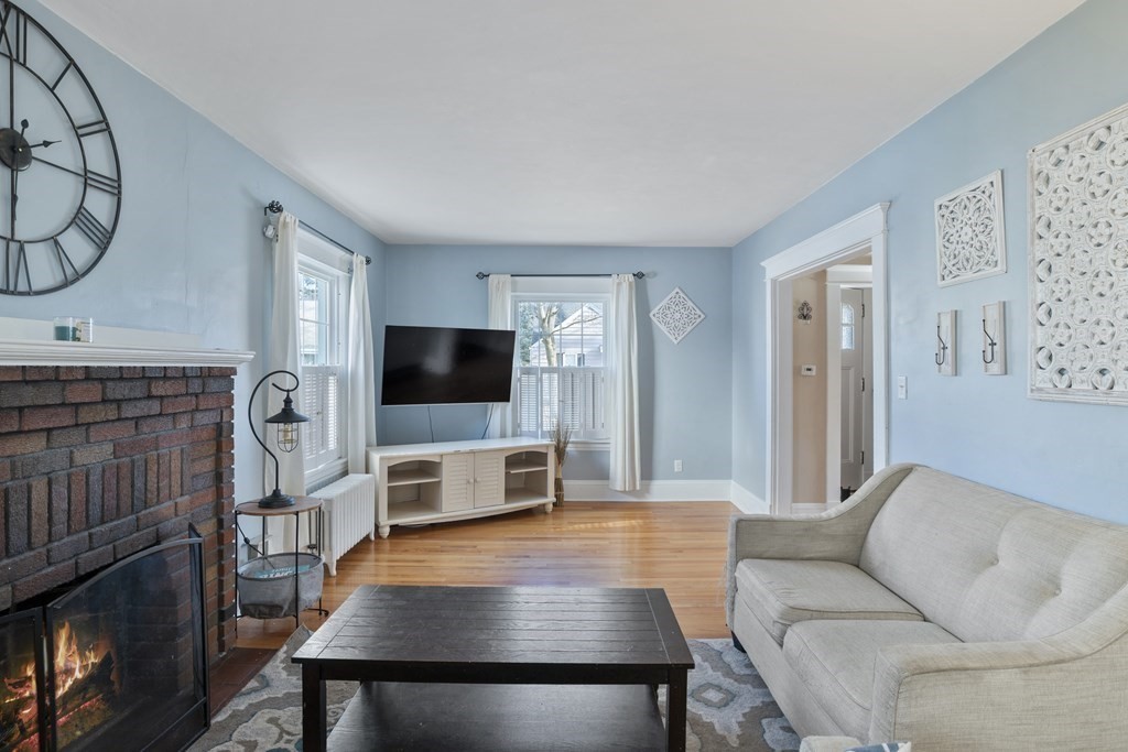 128 Shawmut Street Springfield, MA 01108 - Photo 7 of 39 a living room with furniture a flat screen tv and a fireplace
