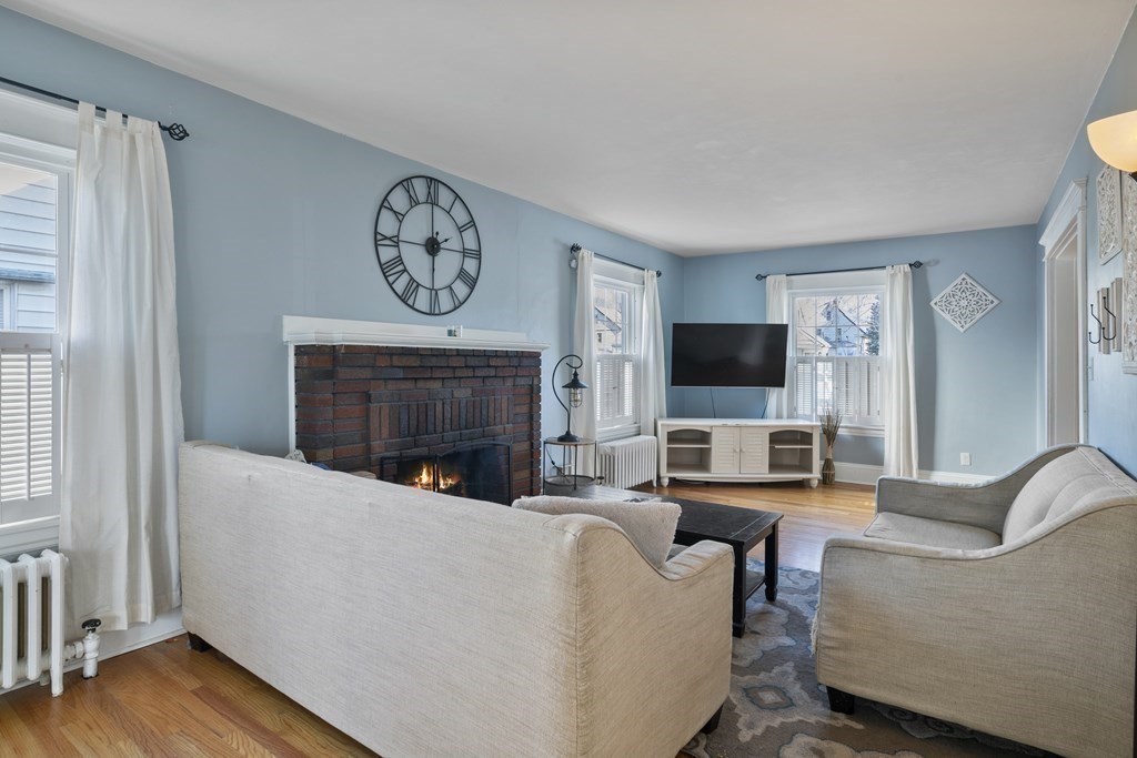 128 Shawmut Street Springfield, MA 01108 - Photo 8 of 39 a living room with furniture a flat screen tv and a fireplace