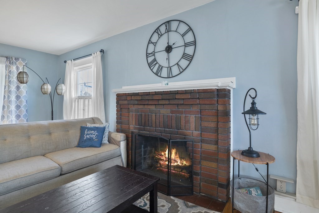 128 Shawmut Street Springfield, MA 01108 - Photo 9 of 39 a living room with furniture and a fireplace