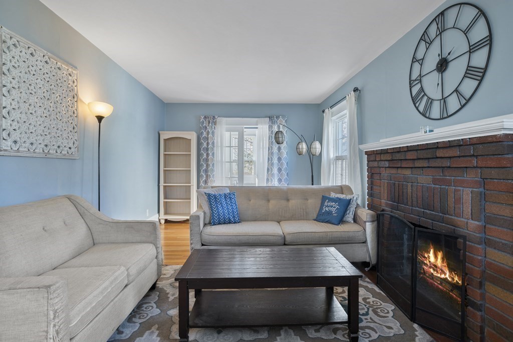 128 Shawmut Street Springfield, MA 01108 - Photo 10 of 39 a living room with furniture and a fireplace