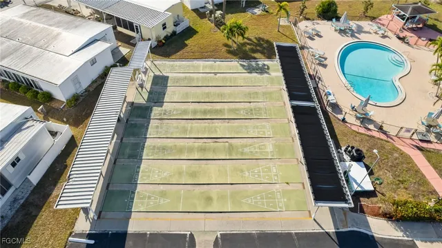 a view of a house with swimming pool and sitting area