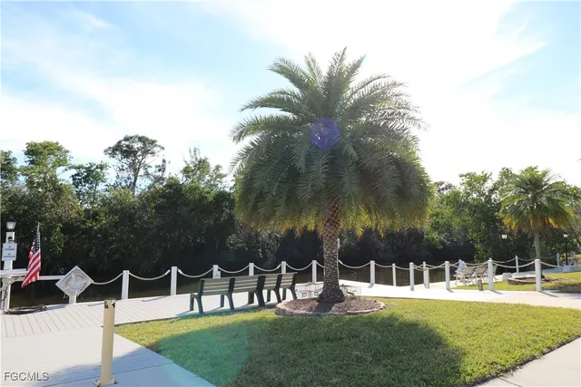 a view of a swimming pool with lawn chairs and a yard