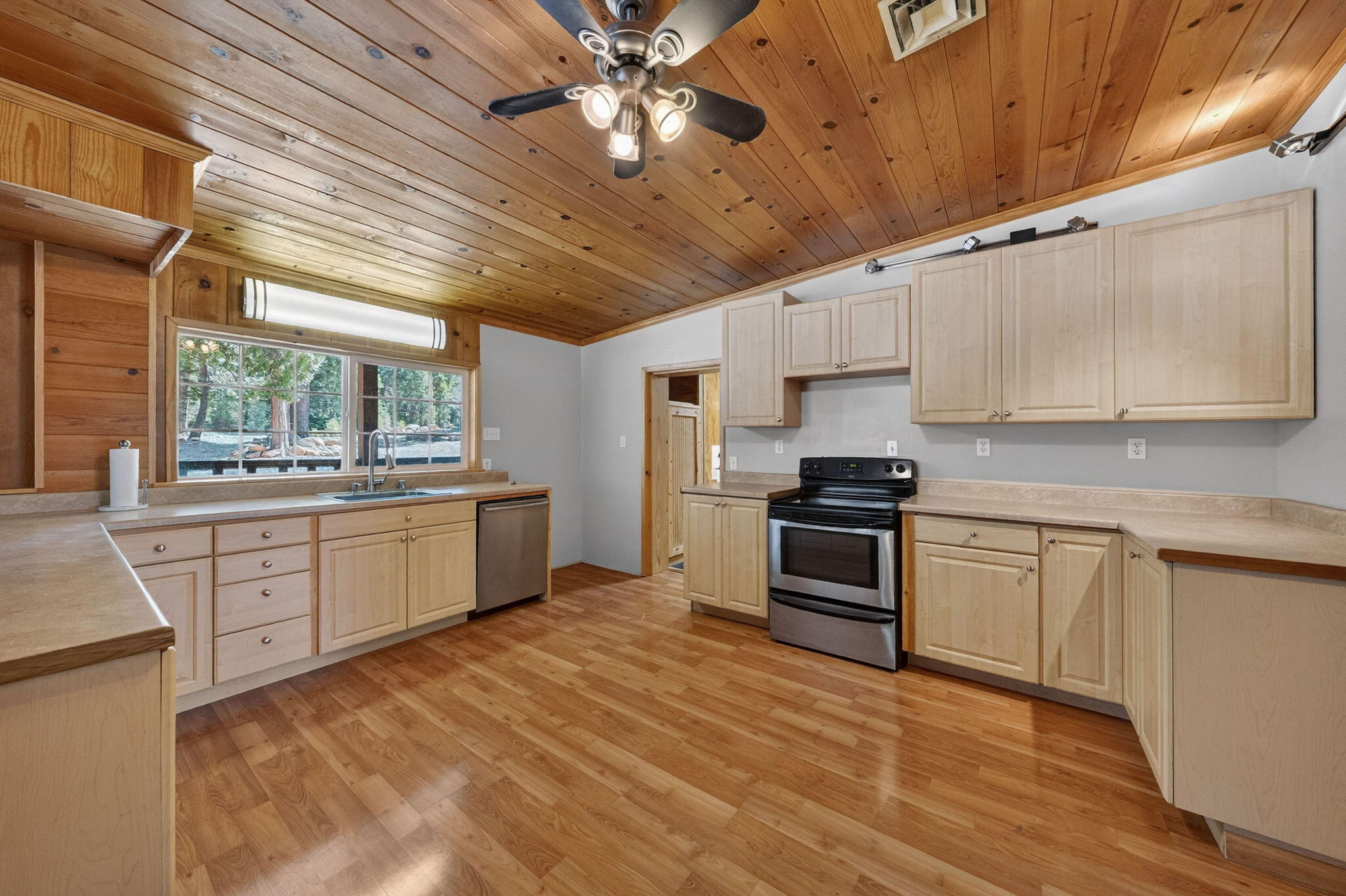7682 Brokeoff Meadows Road Shingletown, CA 96088 - Photo 8 of 26 a kitchen with granite countertop a stove cabinets and a sink