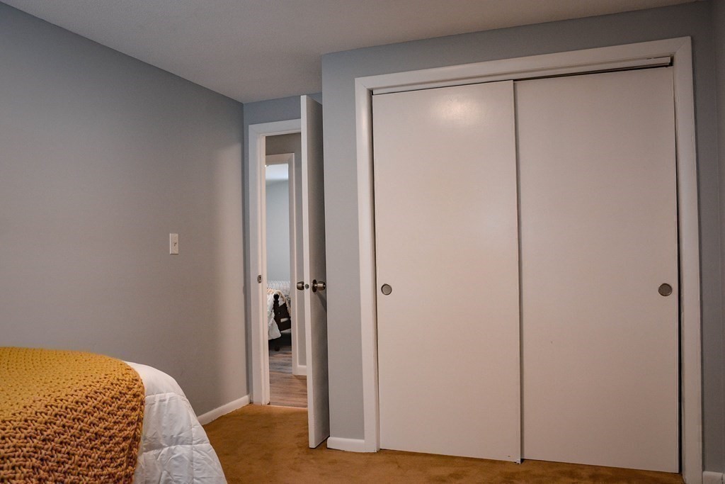144 Partridgeville Road Templeton, MA 01468 - Photo 20 of 33 a bedroom with a bed and wooden floor