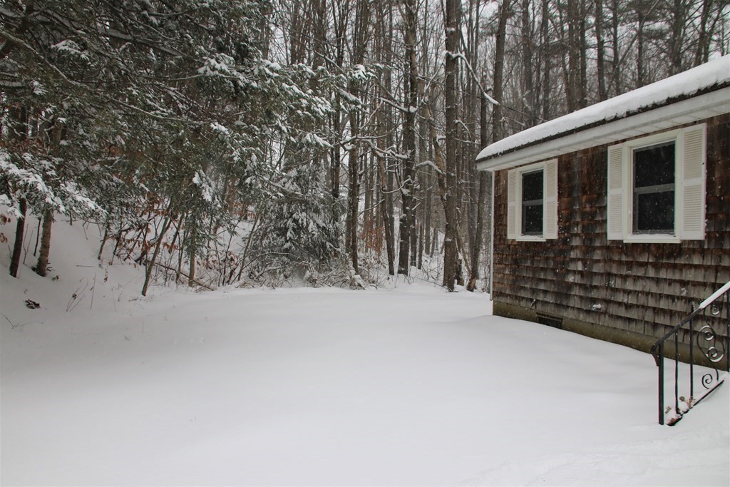 144 Partridgeville Road Templeton, MA 01468 - Photo 29 of 33 a backyard of a house with wooden fence and large trees