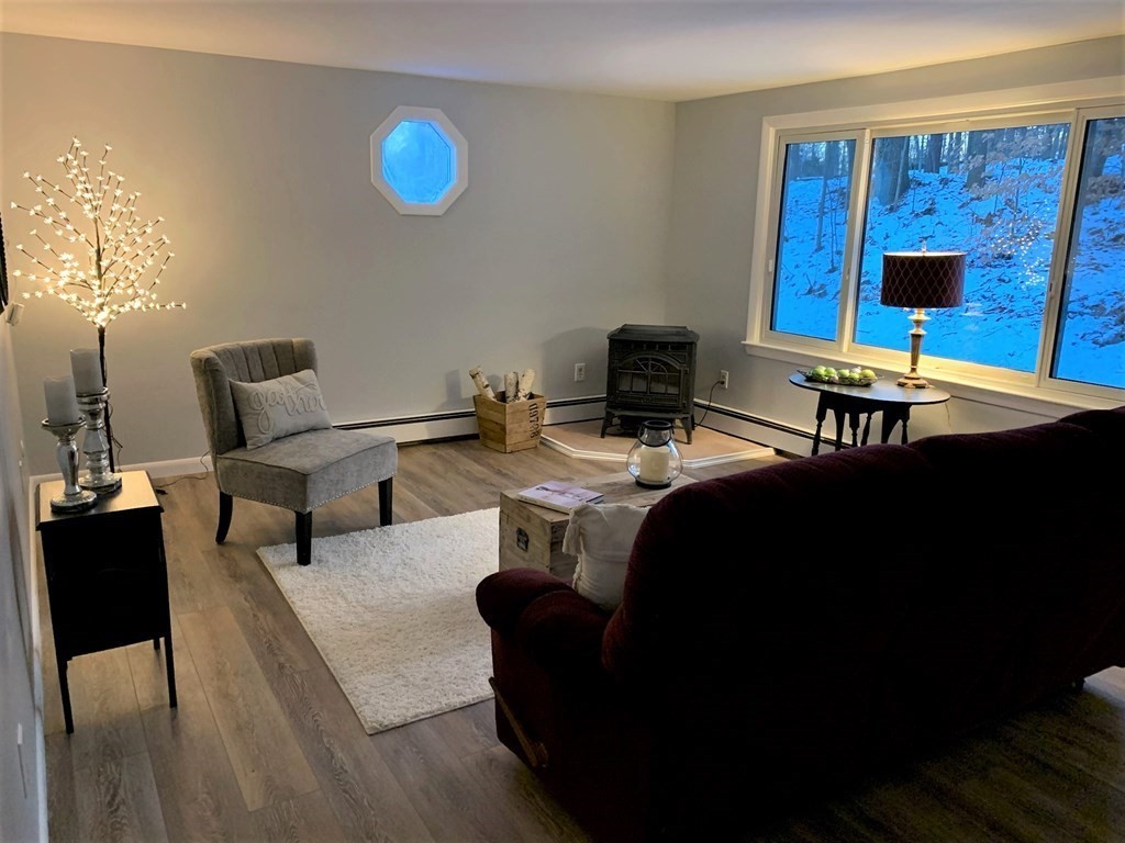 144 Partridgeville Road Templeton, MA 01468 - Photo 10 of 33 a living room with furniture and a table