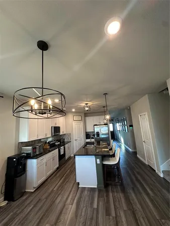 a kitchen view with stainless steel appliances kitchen island a large counter space a sink and appliances