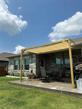 a view of a house with backyard porch and sitting area