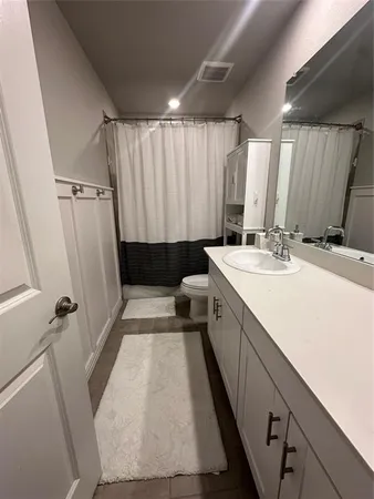 a spacious bathroom with a double vanity sink and a mirror