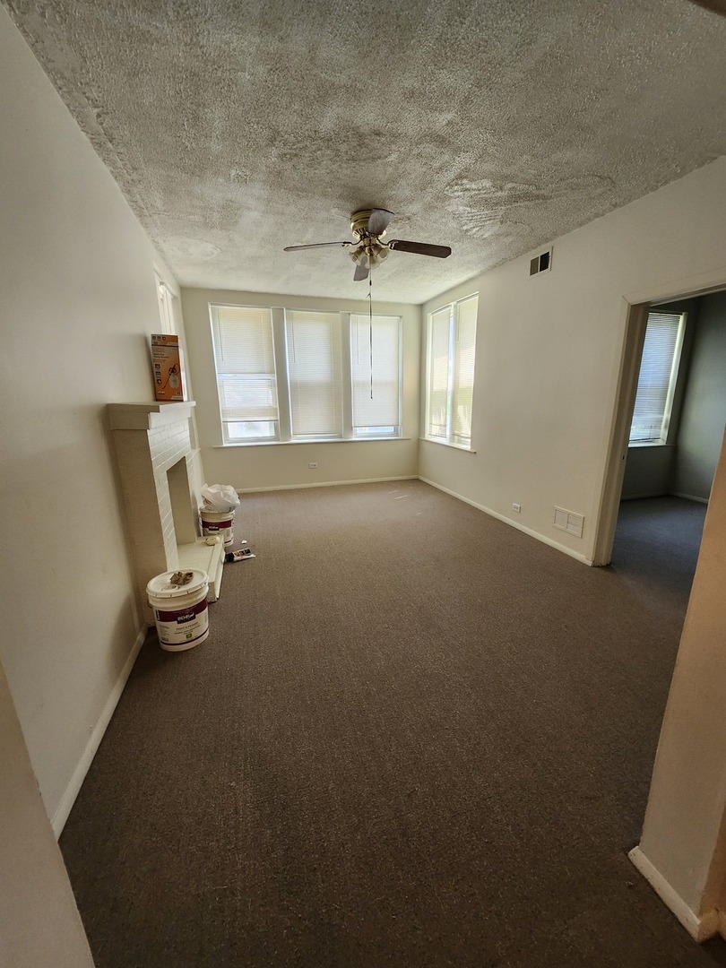 6730 South Clyde Avenue, Unit 1 Chicago, IL 60649 - Photo 8 of 8 an empty room with windows