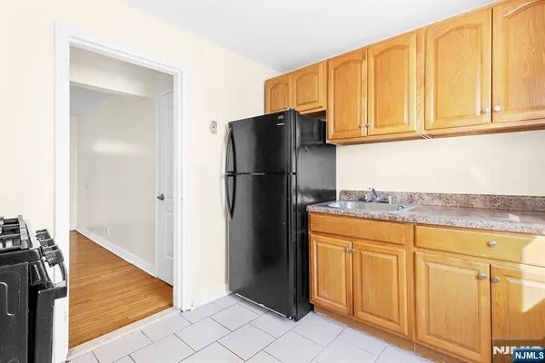 a kitchen with stainless steel appliances granite countertop a refrigerator and a stove
