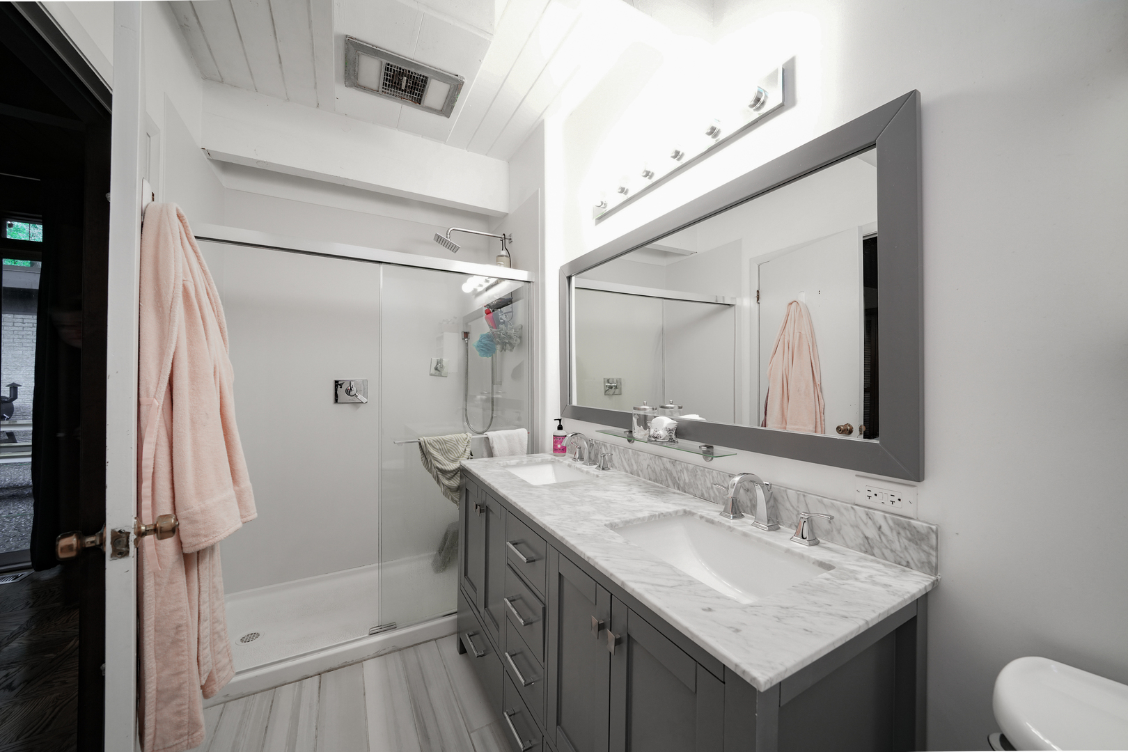 916 Forest Drive Elgin, IL 60123 - Photo 11 of 26 a bathroom with a shower sink vanity and mirror