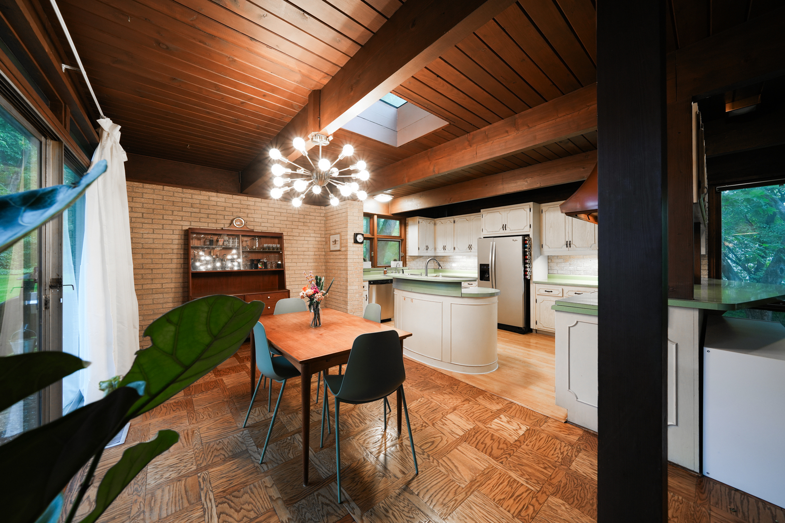 916 Forest Drive Elgin, IL 60123 - Photo 14 of 26 a open kitchen with kitchen island a stove a refrigerator a sink dishwasher and a dining table with garden view