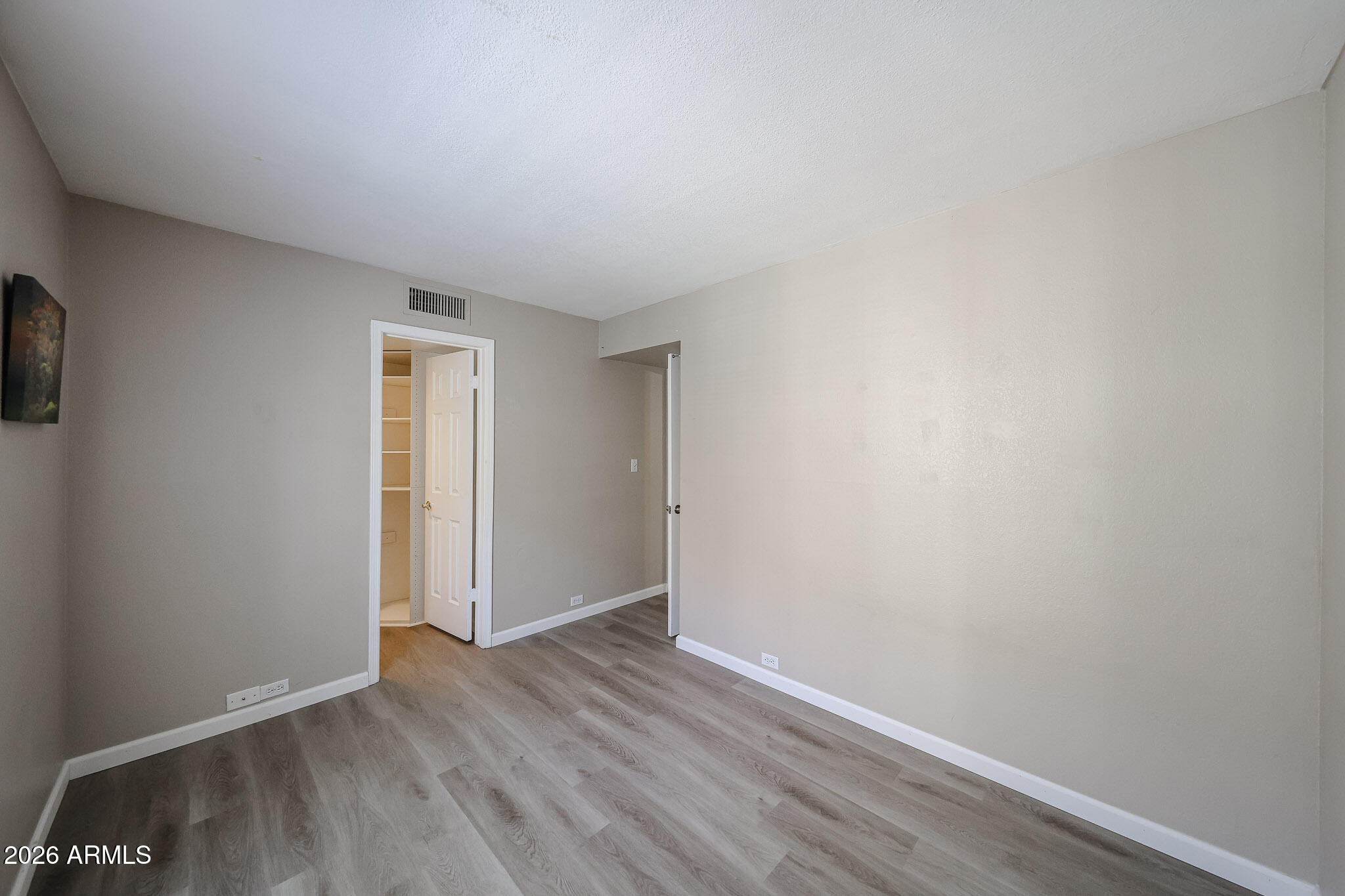 10410 North Cave Creek Road, Unit 1011 Phoenix, AZ 85020 - Photo 32 of 54 a view of an empty room with wooden floor and closet