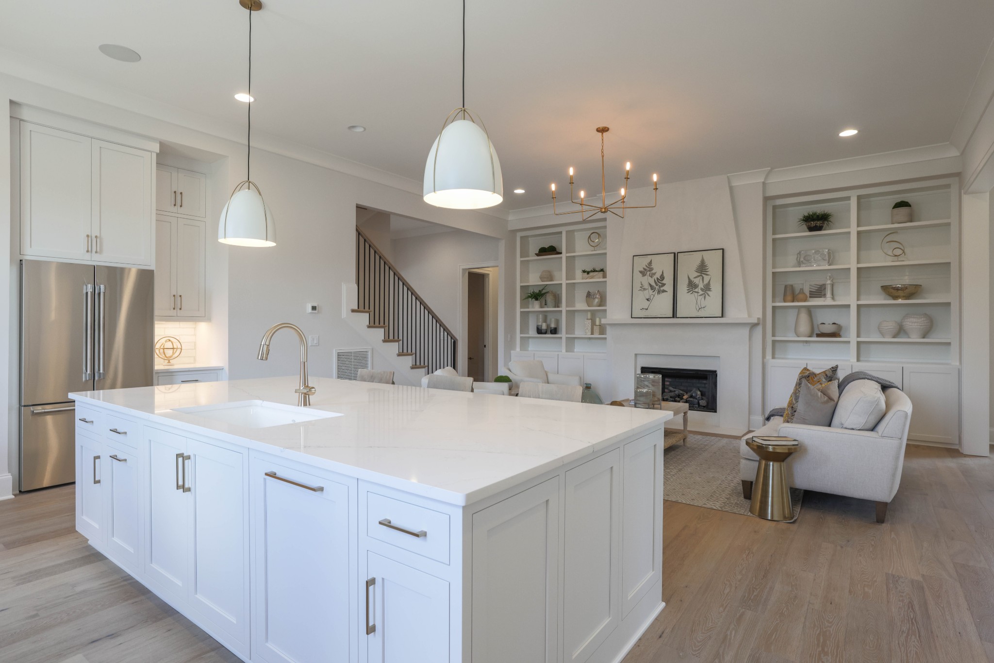 657 Jackson Falls Drive Nashville, TN 37221 - Photo 15 of 63 a large white kitchen with a white center island a sink stainless steel appliances and cabinets