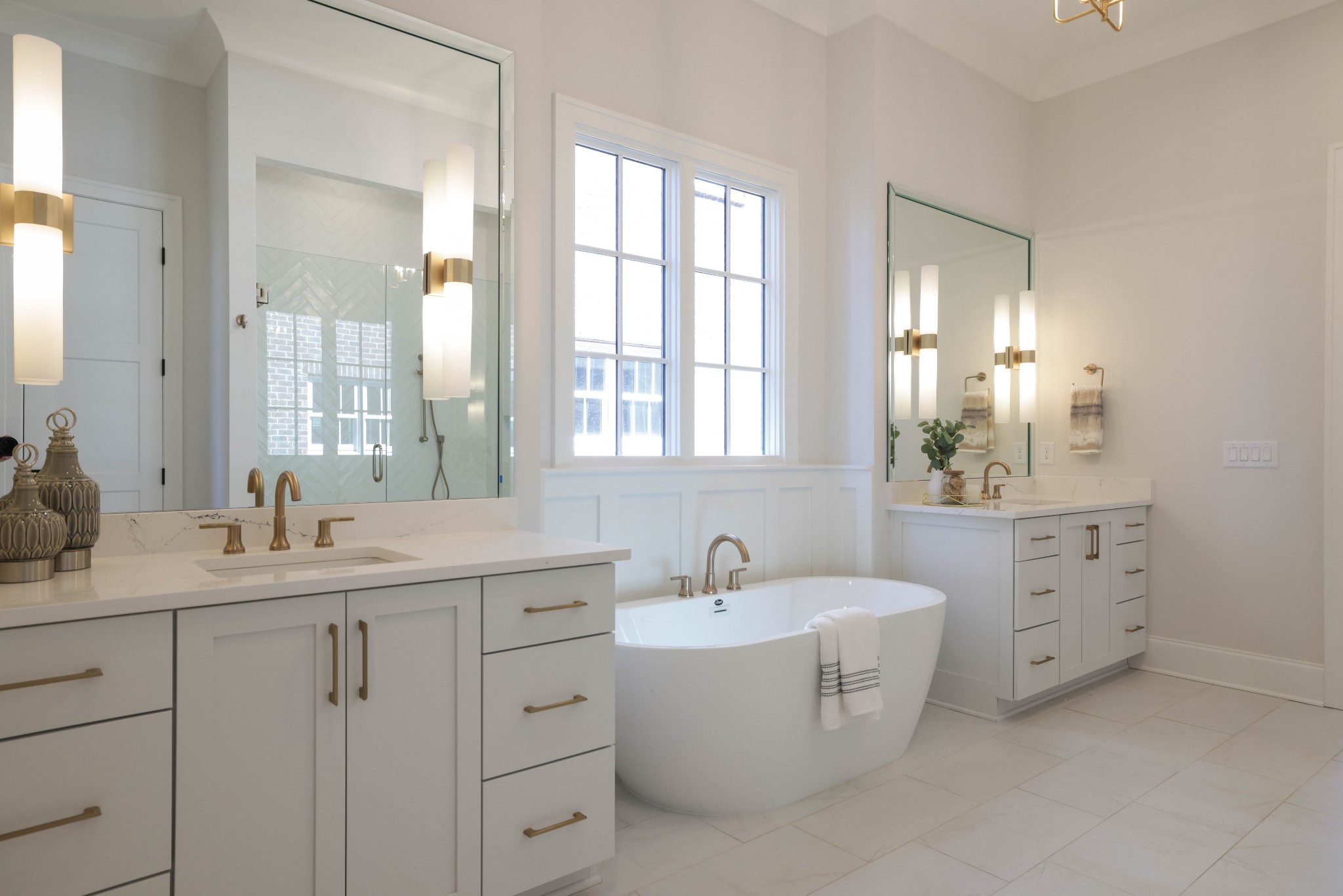657 Jackson Falls Drive Nashville, TN 37221 - Photo 24 of 63 a bathroom with double vanity sink a mirror and a bathtub