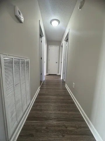 a view of a hallway with wooden floor
