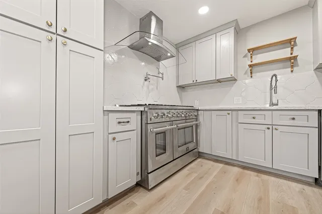 a bedroom with a bed a couch and dresser