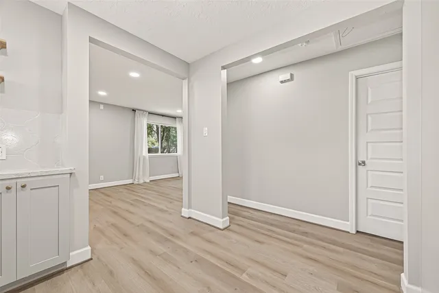 an empty room with a ceiling fan and a window