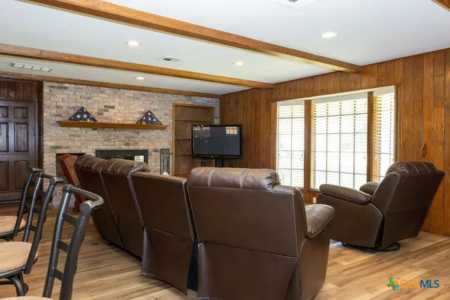 a living room with furniture and a floor to ceiling window