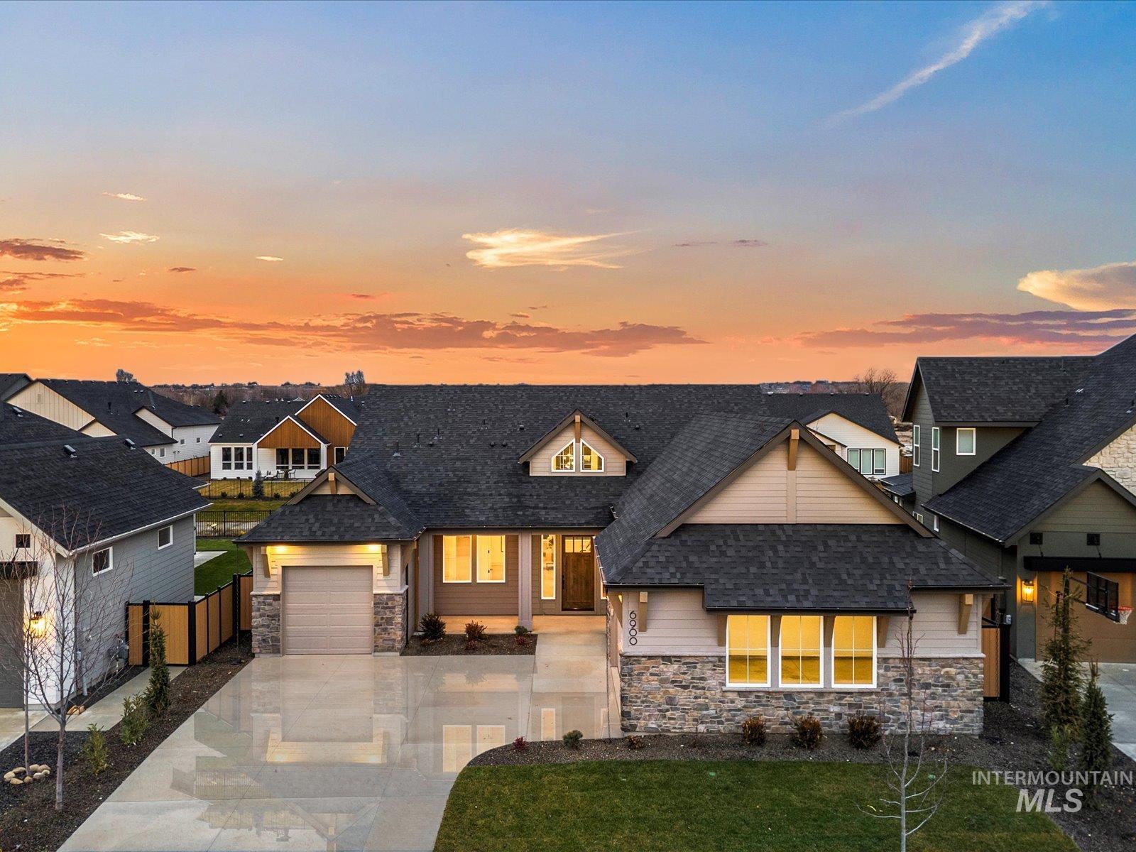 Craftsman inspired home with stone siding, concrete driveway, roof with shingles, a residential view, and a garage