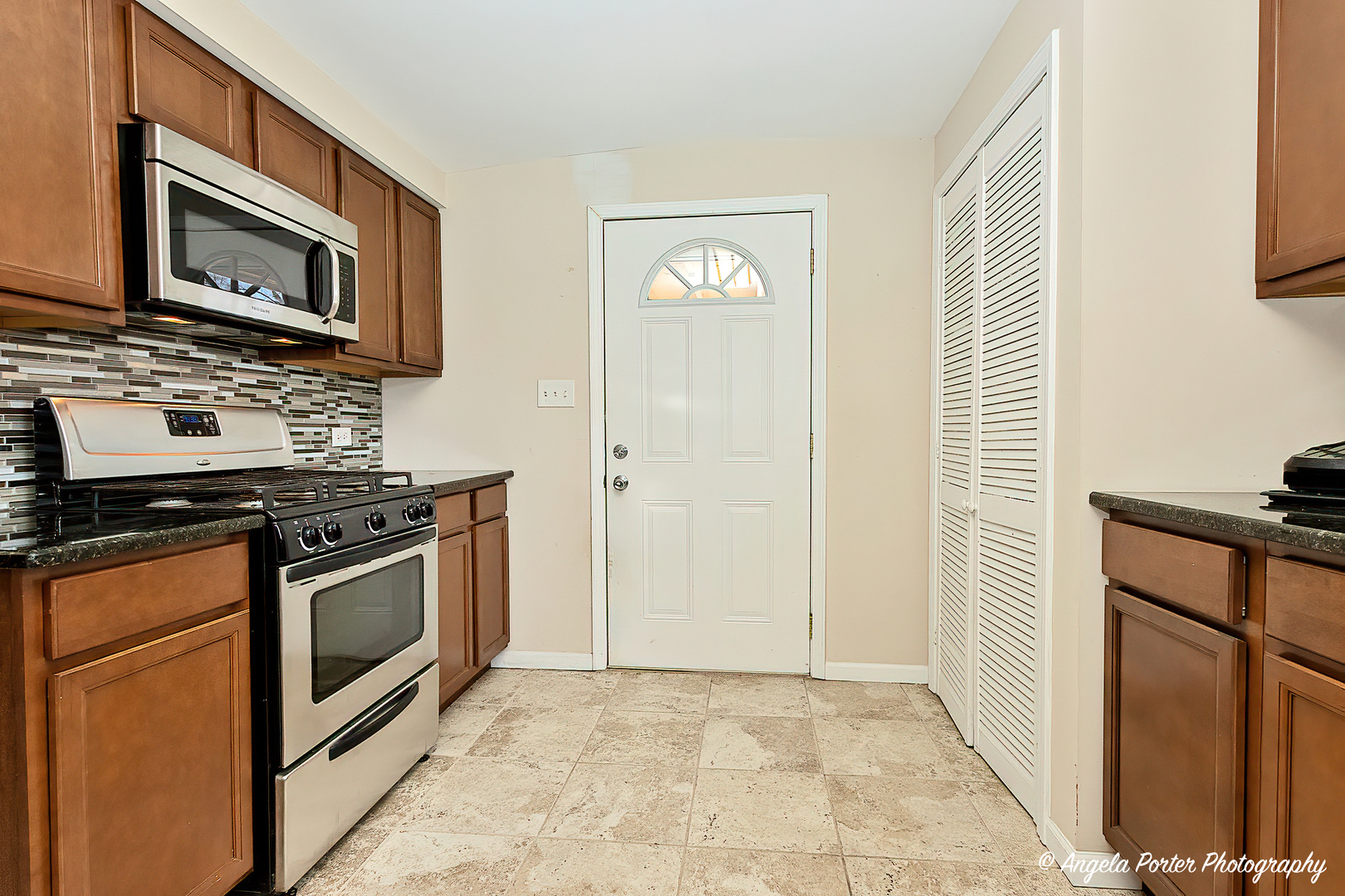 37830 North Watts Avenue Spring Grove, IL 60081 - Photo 3 of 20 a kitchen with granite countertop a stove and a microwave