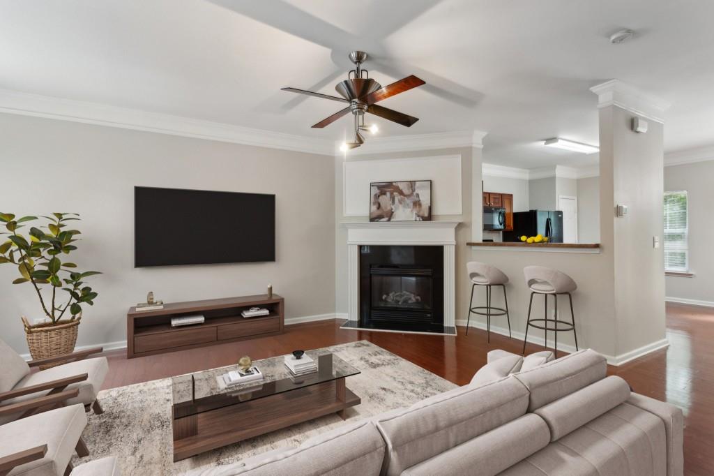 a living room with furniture a flat screen tv and a fireplace