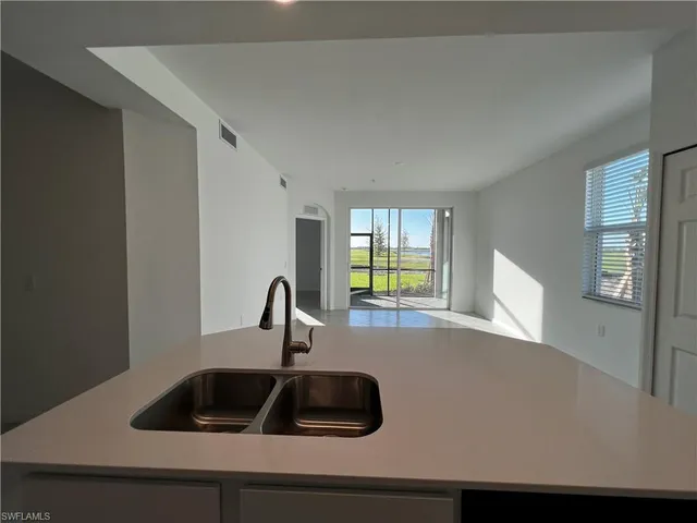 a kitchen with a sink and a window