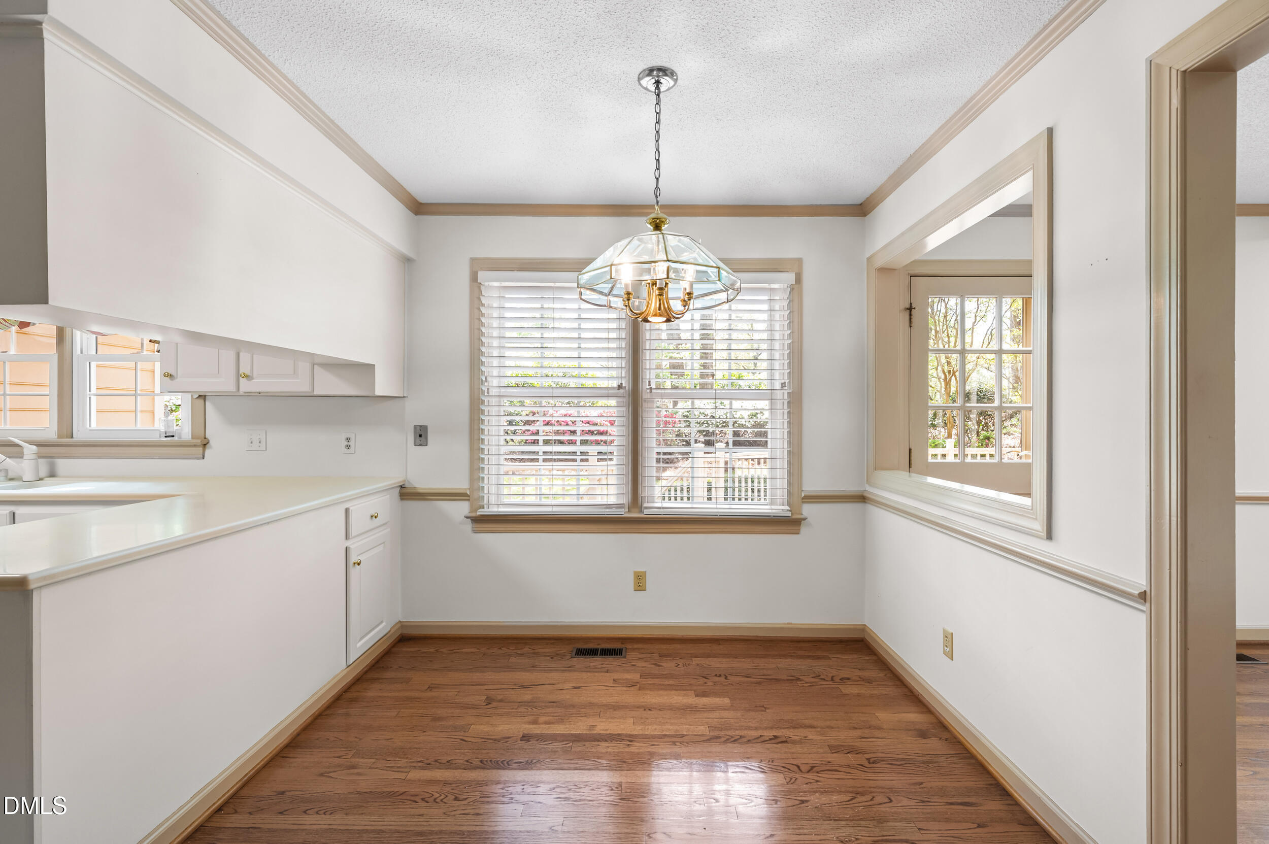 109 Queensferry Road Cary, NC 27511 - Photo 11 of 48 a view of a kitchen with a sink wooden floor and windows