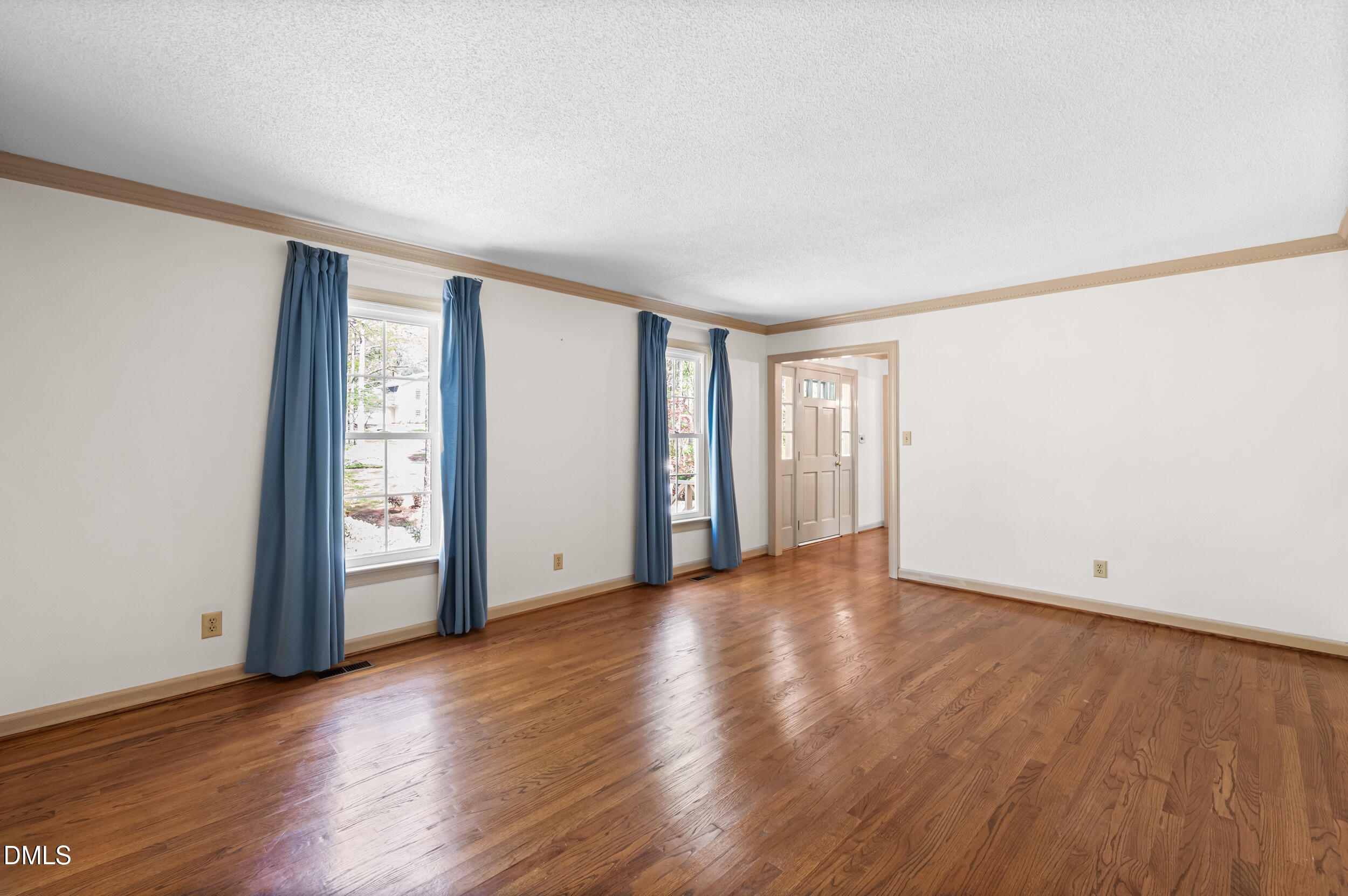 109 Queensferry Road Cary, NC 27511 - Photo 16 of 48 a view of an empty room with wooden floor and a window