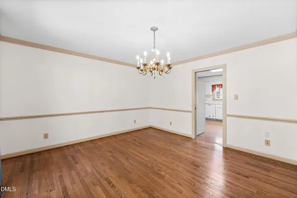 a living room with furniture flat screen tv and a large window