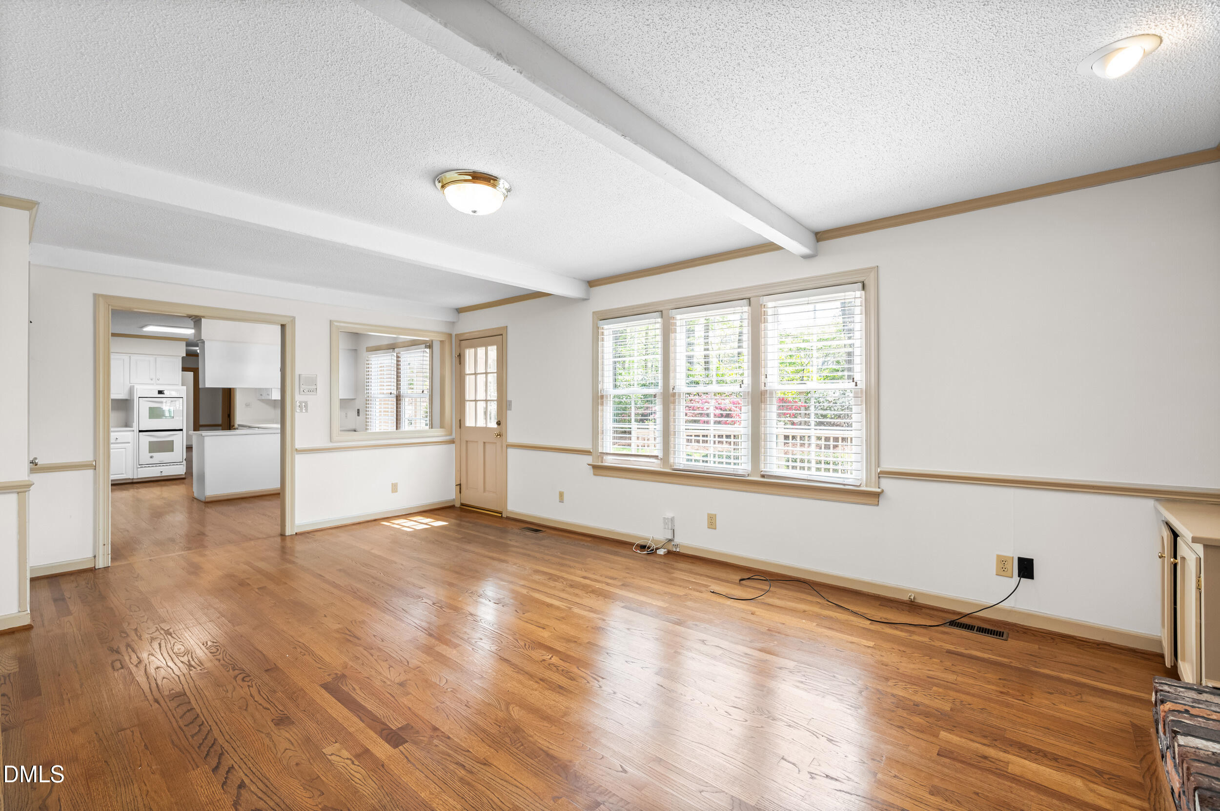 109 Queensferry Road Cary, NC 27511 - Photo 22 of 48 a view of an empty room with window and wooden floor