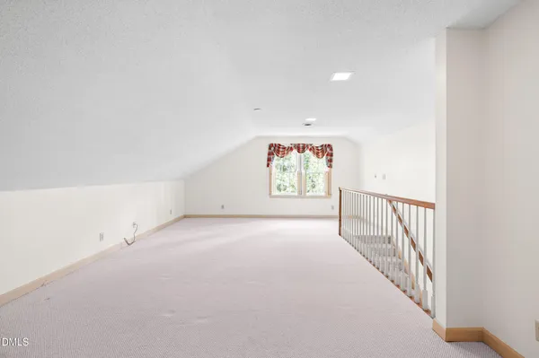 a view of a room with stairs and white walls