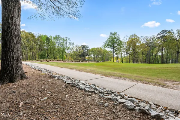 a view of a house with a yard and sitting area