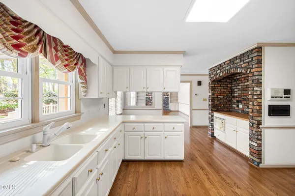 a kitchen with white cabinets and white appliances