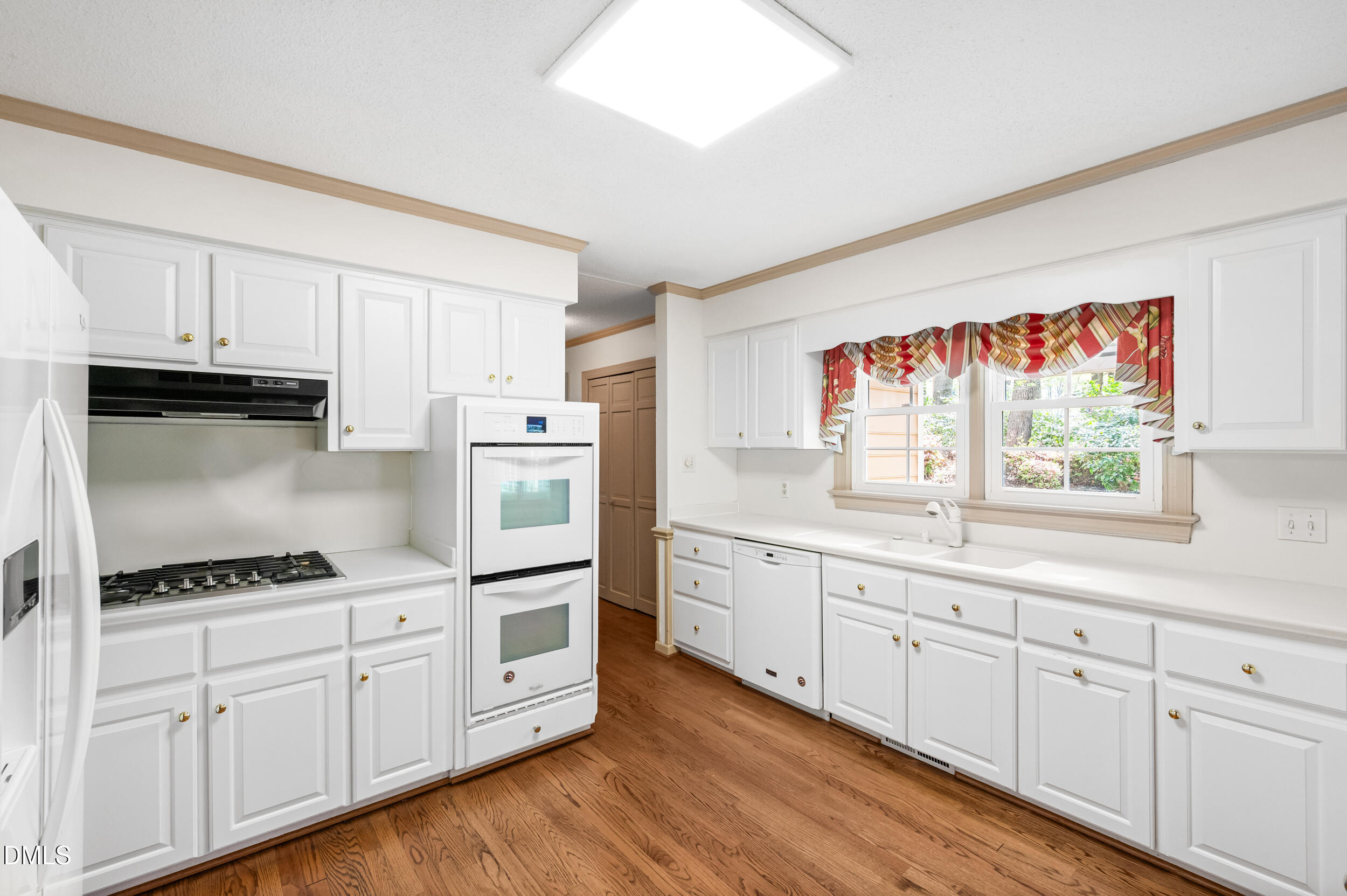 109 Queensferry Road Cary, NC 27511 - Photo 9 of 48 a kitchen with granite countertop white cabinets and white appliances