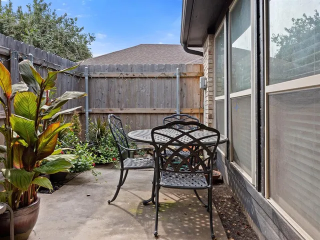 a backyard of a house with table and chairs