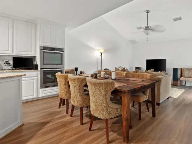 a view of a dining room with furniture and wooden floor
