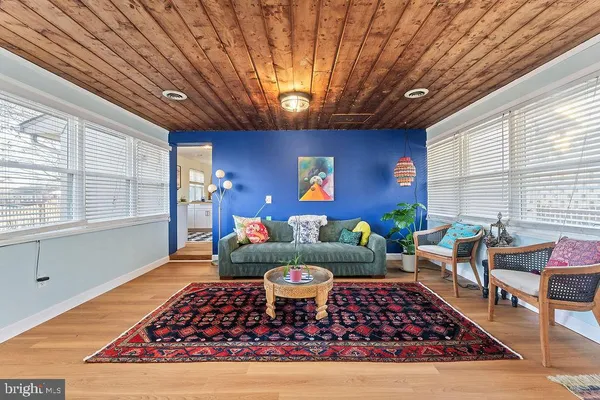 a living room with furniture rug and window