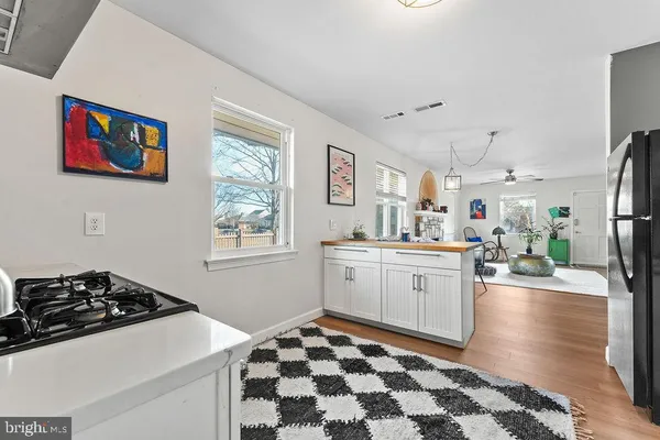a kitchen with sink cabinets and wooden floor