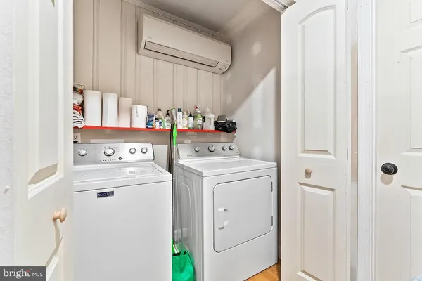 a view of washer and dryer with kitchen in the background