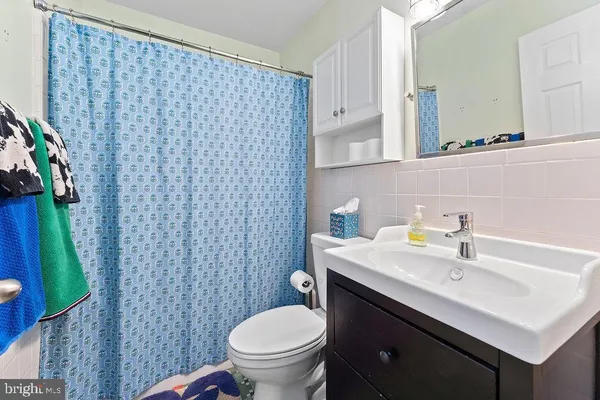 a bathroom with a sink toilet and a mirror